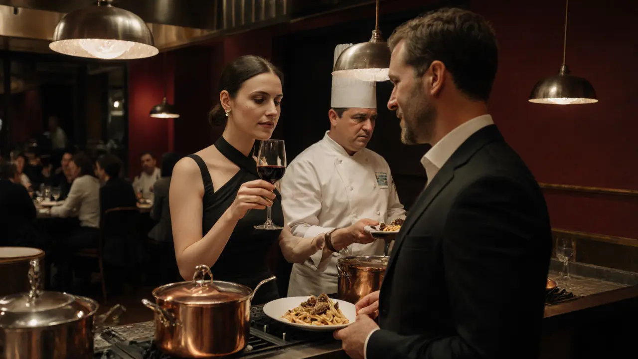 A woman in a black dress explains wine to a client near a Michelin-starred kitchen.